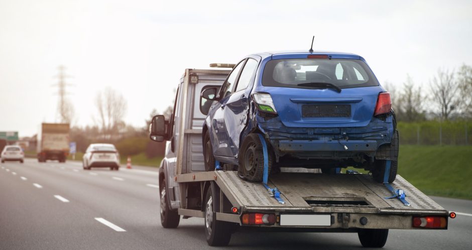 blue-car-trailer-is-being-towed-by-tow-truck blue-car-trailer-is-being-towed-by-tow-truck